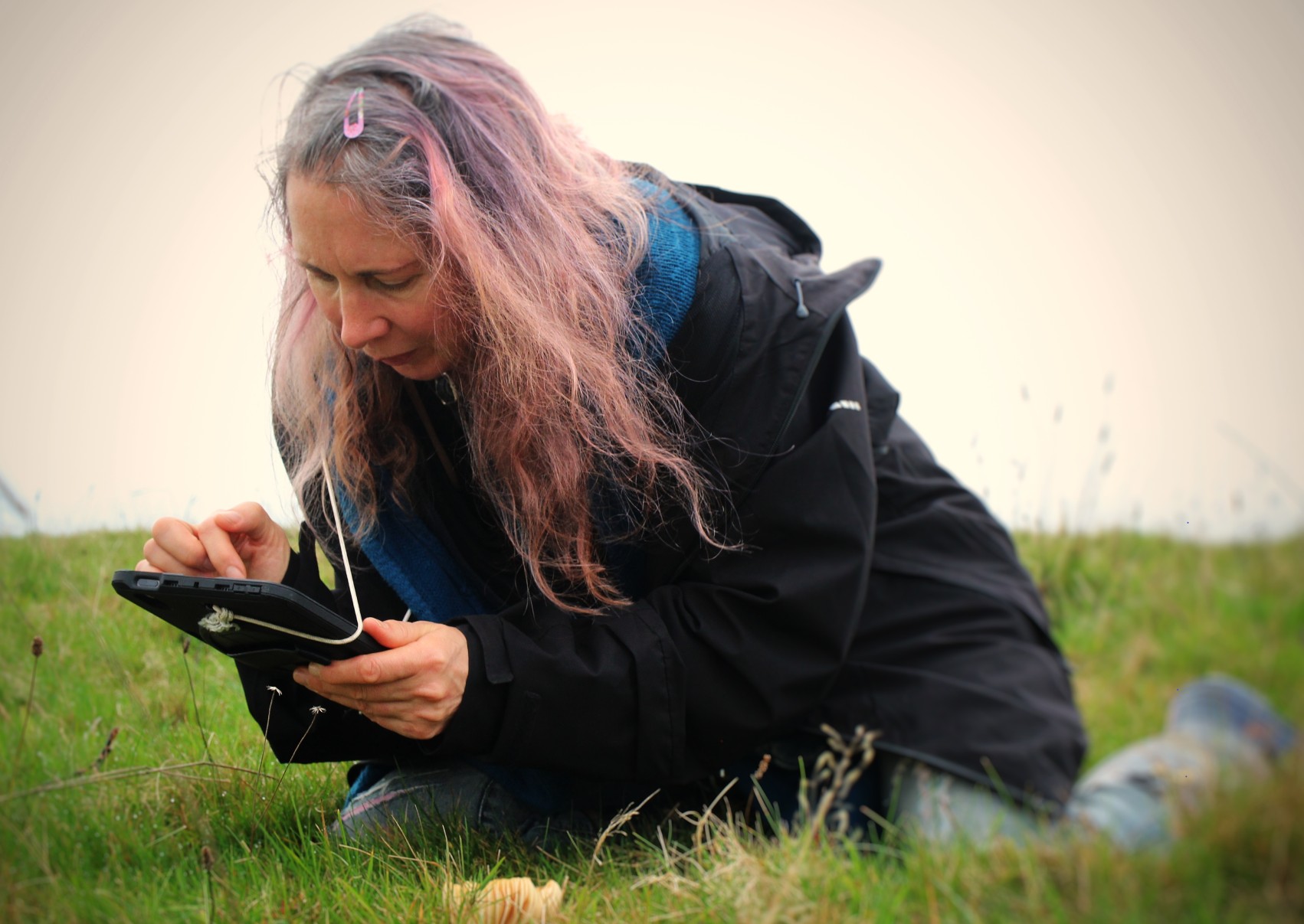 A lady crouching down conducting a plant survey