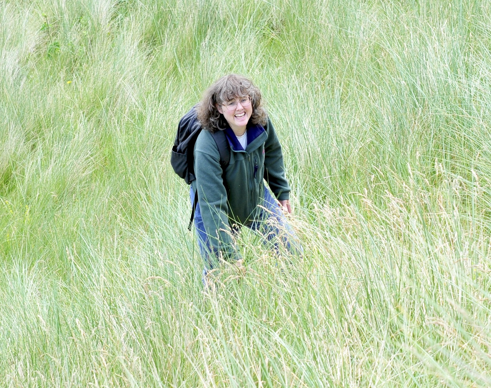 image of a lady walking through long grass